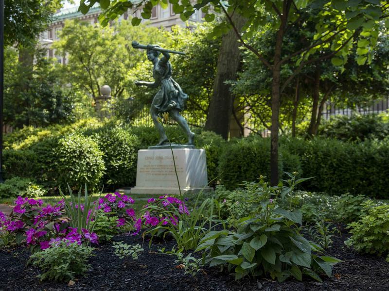 Barnard runner statue on campus in summer